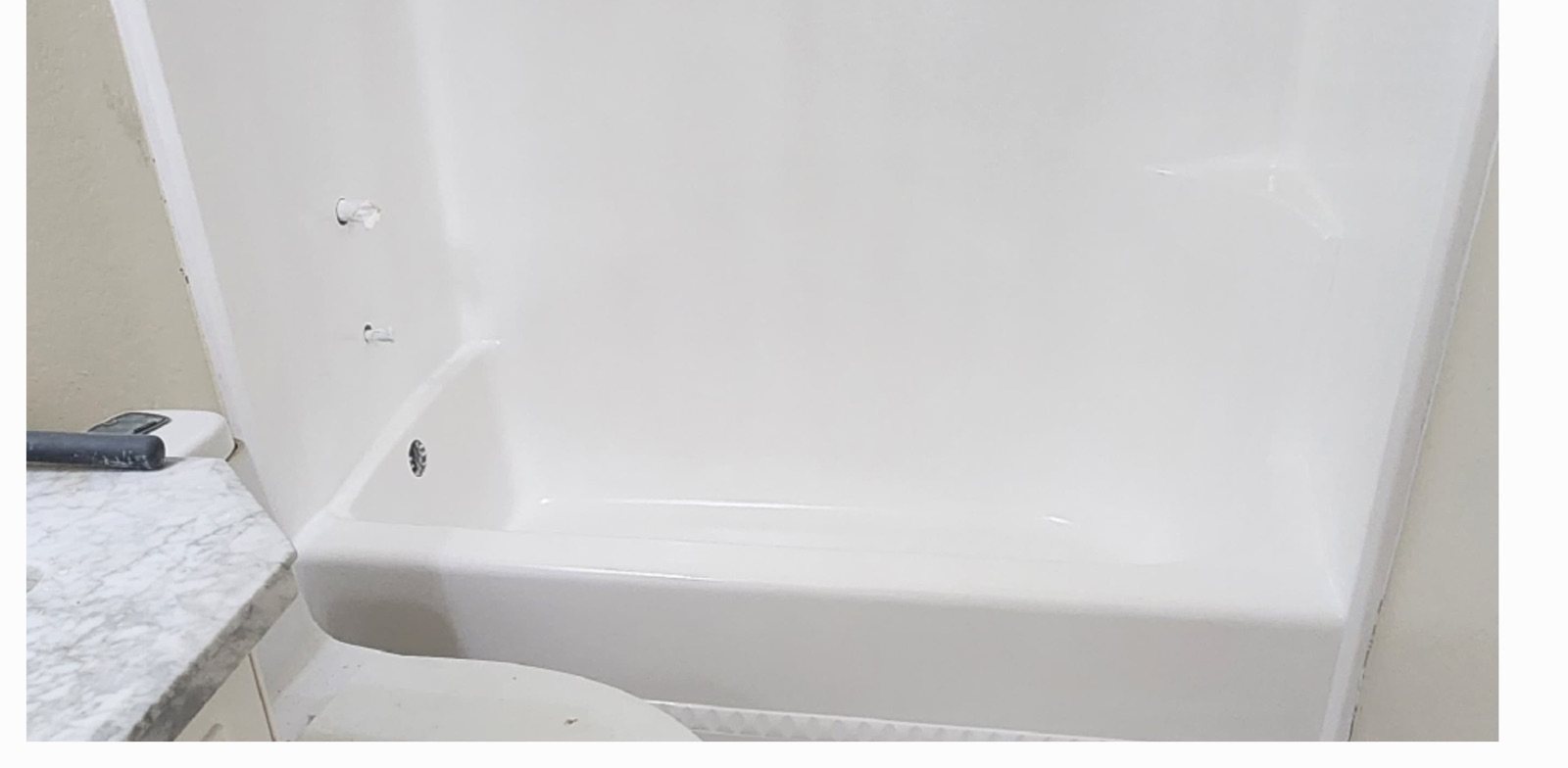 After: rusted and stained bathtub refinished smooth and white