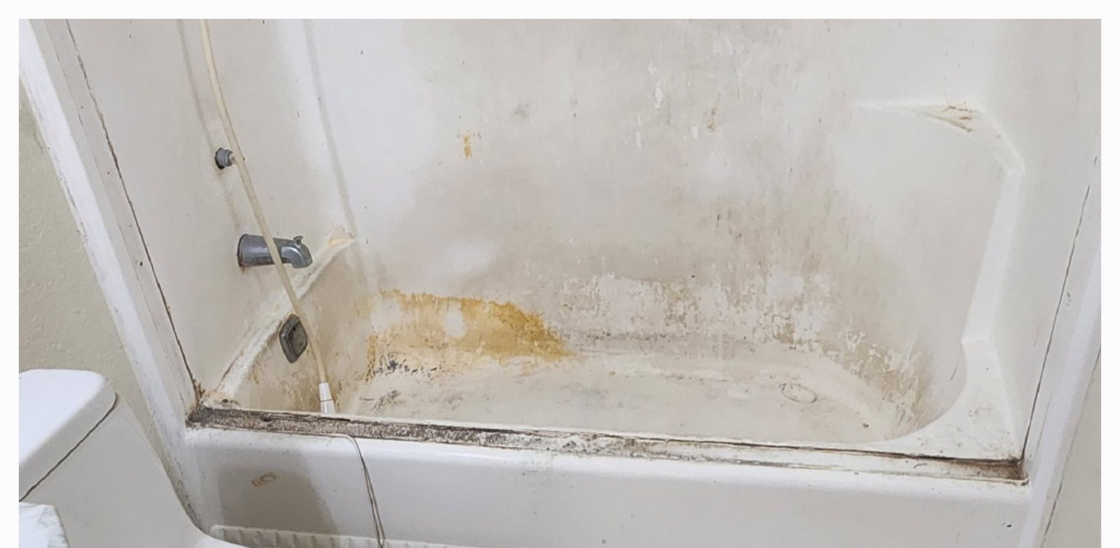 Before: rusted and stained bathtub refinished smooth and white